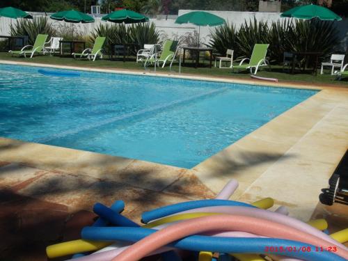 a swimming pool with a bunch of toys next to it at Hotel Puesta del Sol in Punta del Este