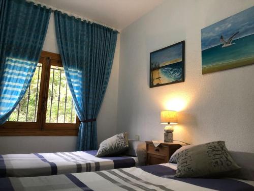 a hotel room with two beds and a window at Finca Grace 