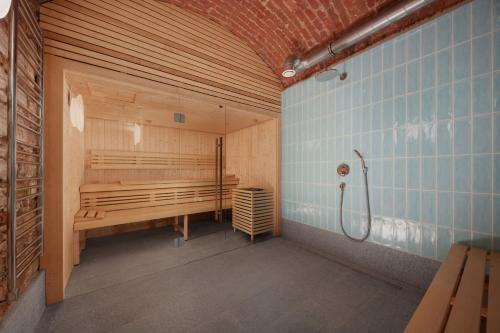 a sauna with a bench and a shower in a room at TurnKey I Premium Apartment in Prague