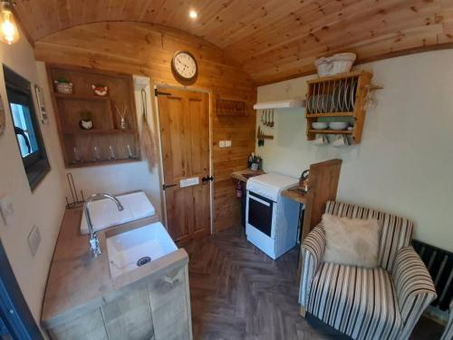 an overhead view of a kitchen in a tiny house at Shepherds Hut with hot tub on Anglesey North Wales in Gwalchmai