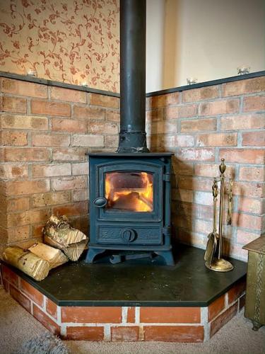 a blue stove sitting in a brick wall at Cosy 2 bed cottage on Dartmoor , Near Ivybridge in Plymouth