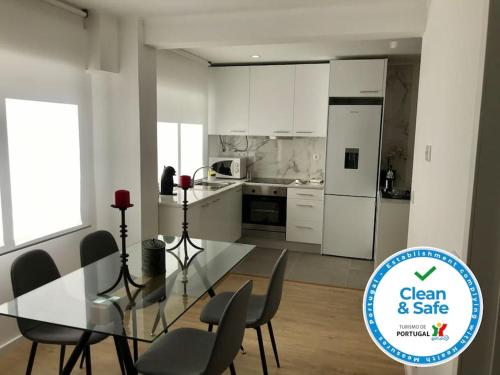 a kitchen with a glass table and chairs in a room at Relax Sintra Home - Near Lisbon in Queluz