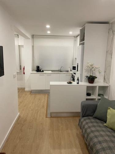 a living room with a couch and a kitchen at Relax Sintra Home - Near Lisbon in Queluz