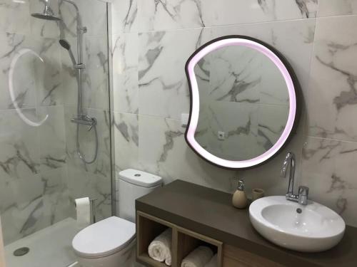 a bathroom with a sink toilet and a mirror at Relax Sintra Home - Near Lisbon in Queluz