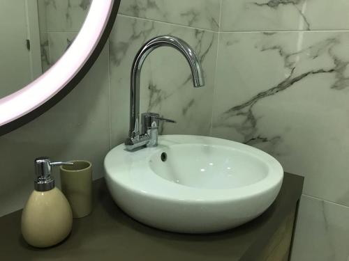 a white sink in a bathroom with a mirror at Relax Sintra Home - Near Lisbon in Queluz