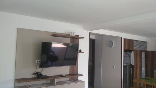 a flat screen tv on a wall in a living room at Villa Campestre Lago Calima in Calima