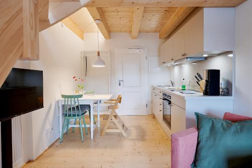 a small kitchen with a table and a kitchen with a counter at Gutshof Schirgiswalde in Schirgiswalde