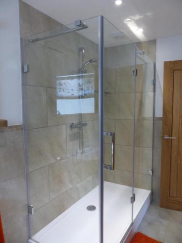 a shower with a glass door in a bathroom at Menhyr in Carbis Bay