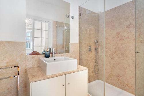 a bathroom with a white sink and a shower at WHome Alecrim 43 Top Location perfect to explore Lisbon in Lisbon