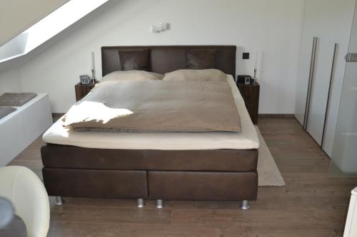 a large bed in a room with a staircase at 5 Sterne Apartment Auszeit in Wilhelmsfeld
