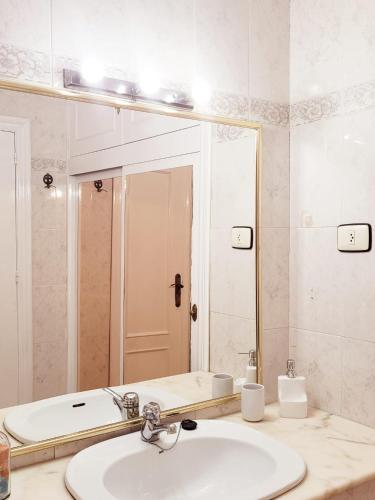 a bathroom with a sink and a mirror and a tub at Casa Rural El Cornijal - Piscina Privada in San Javier