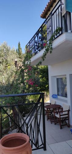 - Balcón de un edificio con 2 bancos de madera en Villa Myrto - Beautiful see-view villa, en Stafylos