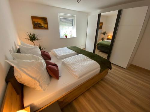 a bedroom with a large bed with a large mirror at Ferienwohnung mit Salzachblick in Laufen
