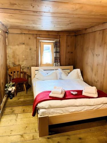 a bedroom with a bed with two towels on it at Chesa Margadant in Zuoz