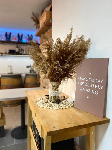 a table with a vase with a plant on it at Palavahof in Perná