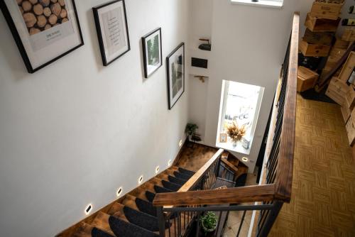 a staircase in a house with pictures on the wall at Palavahof in Perná