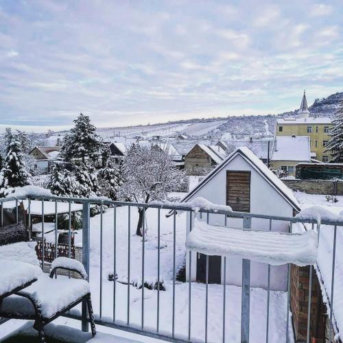 a balcony covered in snow with a house at Palavahof in Perná