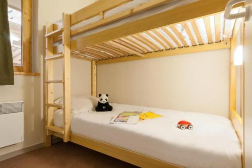 a panda bear sitting on top of a bunk bed at Cosy Val Tho ski aux pieds in Val Thorens