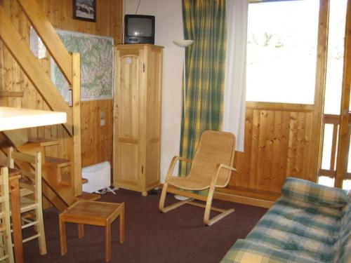 a living room with a couch and a chair at Appt Plagne Village skis aux pieds - LES HAMEAUX 2 in Plagne Villages