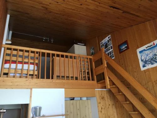 a room with a wooden staircase in a house at Appt Plagne Village skis aux pieds - LES HAMEAUX 2 in Plagne Villages