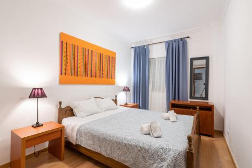 a bedroom with a bed and a mirror on the wall at #056 Old Post Office by Home Holidays in Albufeira