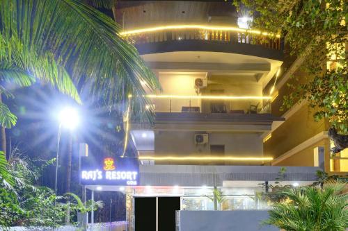 a building with a neon sign in front of it at Itsy By Treebo - Raj Resort, Calangute in Calangute