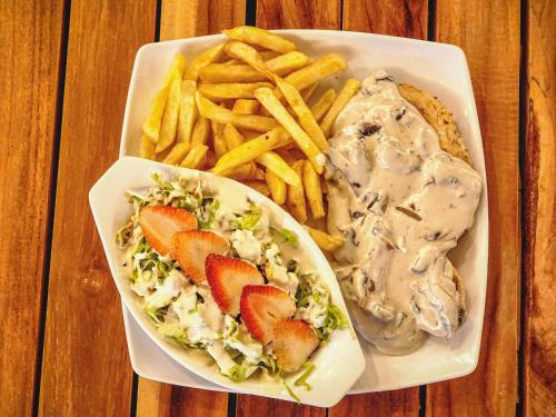 a plate of food with a sandwich and french fries at MIRADORES DEL PARAISO in Doradal