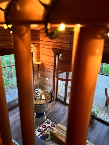 a view of a room with a table in a cabin at Kaimukas - namelis prie ežero keturiems in Dvarčėnai