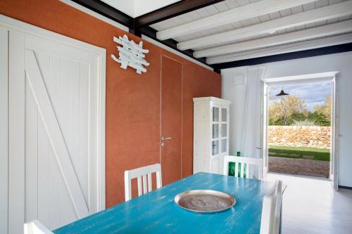 a dining room with a blue table and chairs at I Carusi Relais in Noto