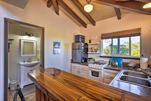 a kitchen with a wooden counter top and a sink at Peaceful Milolii Cottage with Ocean and Sunset Views! in Papa Bay Estates