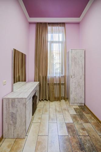 an empty room with pink walls and a window at H Resort Hotel Vagharshapat Armenia in Vagharshapat