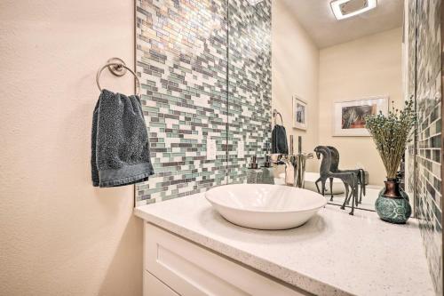 a bathroom with a bowl sink and a mosaic wall at Large Santa Fe Townhouse with Private Patio! in Santa Fe