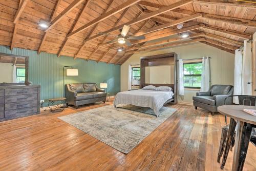 a bedroom with a bed and two chairs in a room at Cassopolis The Cabin Retreat Lake Access! in Cassopolis