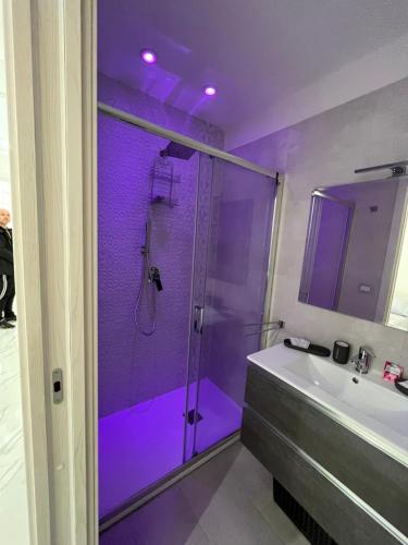 a purple bathroom with a shower and a sink at DG Sweet Home in Naples