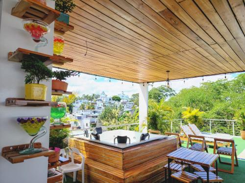 a patio with a hot tub on a deck at MIRADORES DEL PARAISO in Doradal