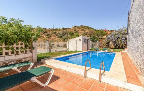 a swimming pool in the backyard of a house at Awesome Home In Rincón De La Victoria in Rincón de la Victoria