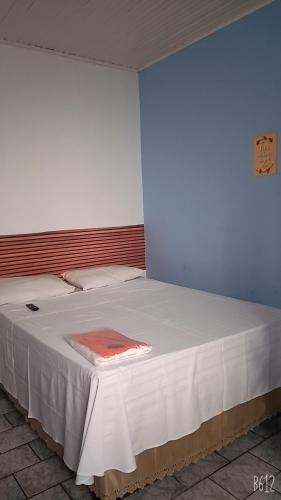 Ένα ή περισσότερα κρεβάτια σε δωμάτιο στο Minha casa pousada
