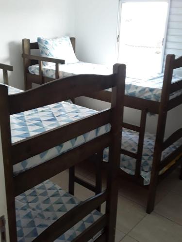 a group of bunk beds in a room at casa de praia campos in Itanhaém