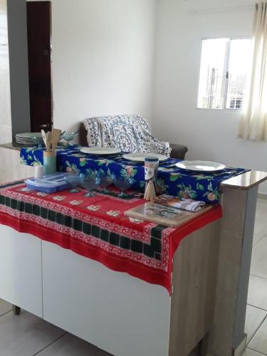 a table with plates on top of a table at casa de praia campos in Itanhaém