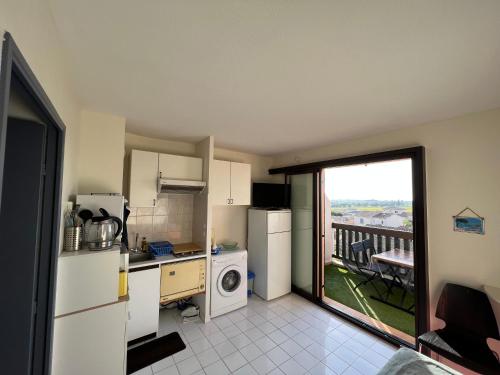 a kitchen with a refrigerator and a dishwasher at T2 cabine La Londe les Maures 4 personnes magnifique vue mer in La Londe-les-Maures