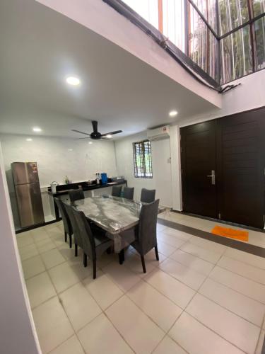 a dining room with a table and chairs at 15PAX 3 BR, Kids Swimming Pool, Pool table, BBQ near Spice ARENA, Airport Penang in Bayan Lepas
