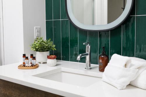 a bathroom with a sink and a mirror at The Station by Compo Hotels in Travelers Rest