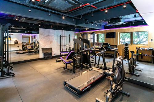 a gym with several treadmills and machines in a room at Mar Ipanema Hotel in Rio de Janeiro