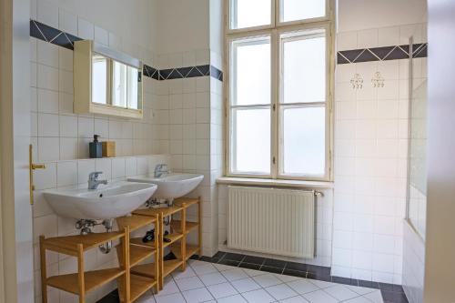 a bathroom with two sinks and a window at Central Living Apartments - Universität in Vienna