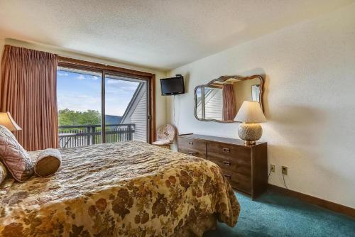 a bedroom with a large bed and a large window at Sunrise Timberline I4 in Killington