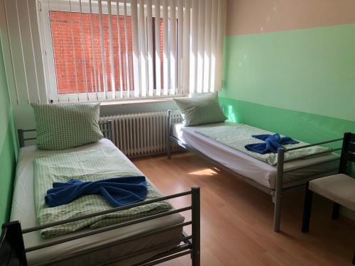 um pequeno quarto com 2 camas e uma janela em Ritfa 2 em Heide