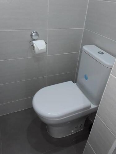 a bathroom with a white toilet in a stall at La Perle du Rocher in Le Diamant