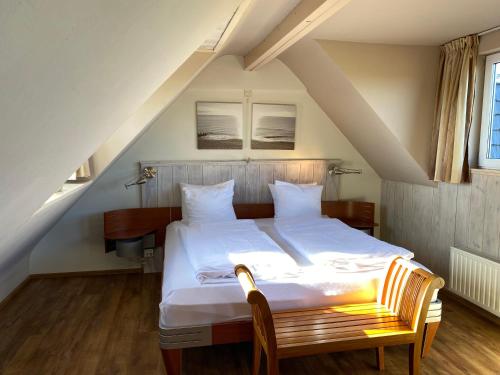 a bedroom with a large white bed in a attic at ’t Huuske in Zonnemaire