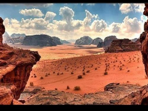 a group of people in a desert with rocks at Star Wars Wadi Rum in Wadi Rum