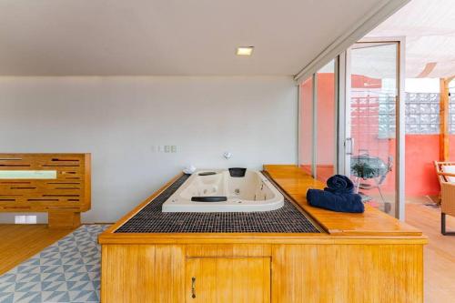 a bath tub sitting on top of a counter in a room at Stylish apartment with private roof top & jacuzzi in Mexico City